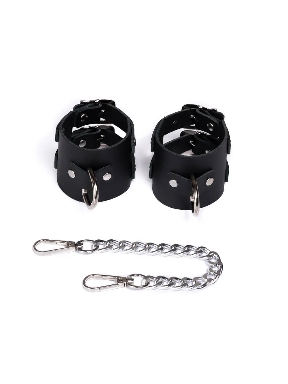 Kinky erotic leather handcuffs with a chain for tying.
